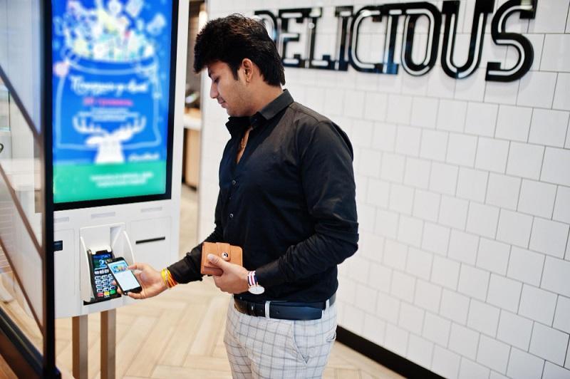 Man-using-a-tech-equipped-kiosk-with-kiosk-accessibility