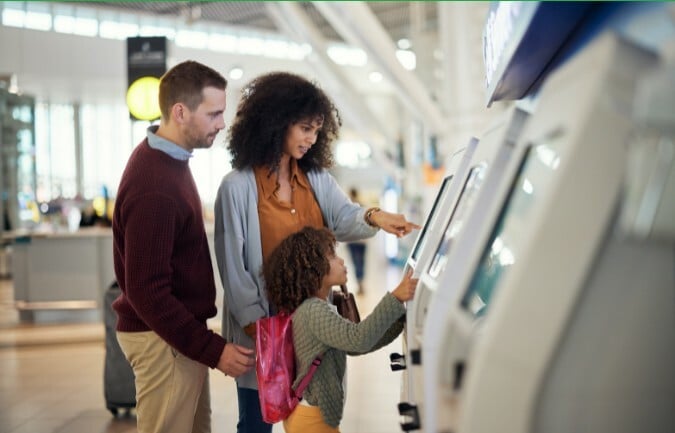 family using self service kiosk