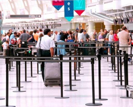 people waiting in lines at airport