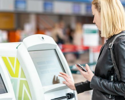 women using kiosk at public place