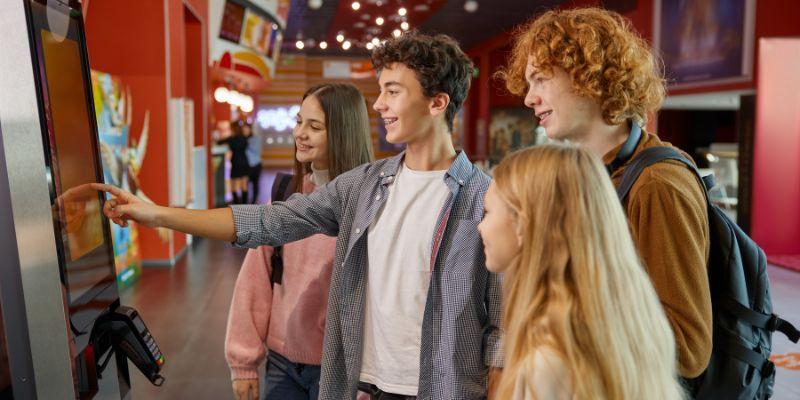 A-group-of-teens-using-self-service-kiosk-to-place-a-food-order