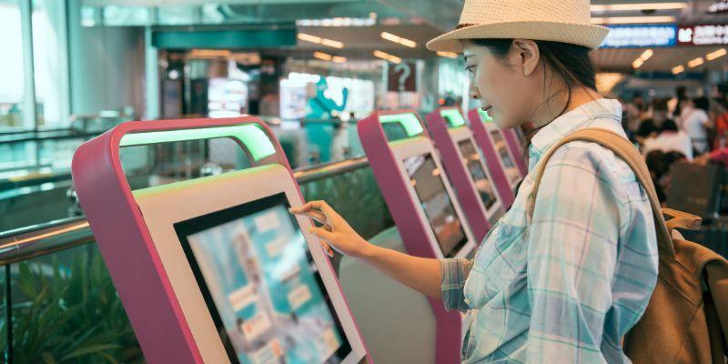 A-woman-using-self-service-kiosk-in-an-airport