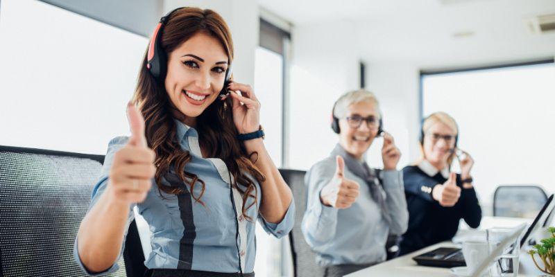 Group-of-customer-service-representatives-giving-thumbs-up-sign-to-signify-customer-satisfaction-as-a-result-of-brand-experience-mapping