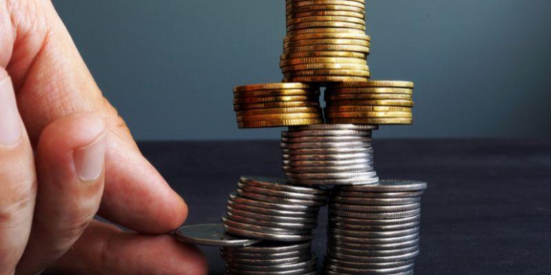 A-person-toppling-coins-representing-financial-challenges