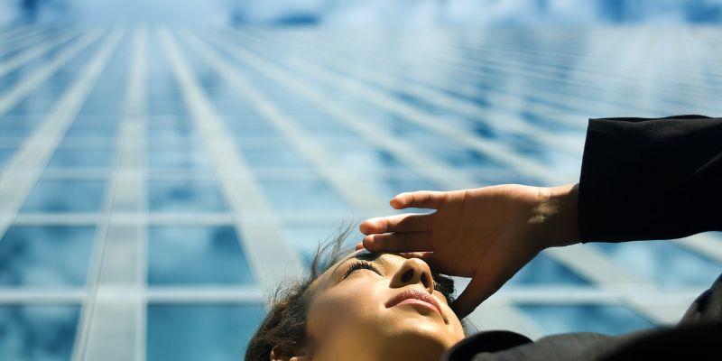 A-woman-looking-out-with-corporate-building-in-the-back