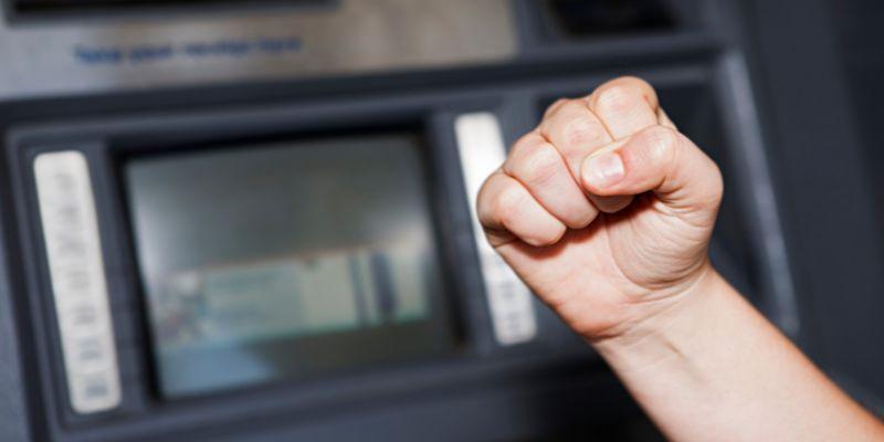 A-customer-tightens-fist-in-frustration-due-to-a-malfunctioning-ATM