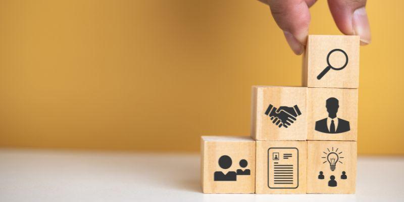 Wooden-blocks-stacked-with-logos-representing-employee-training-and-development