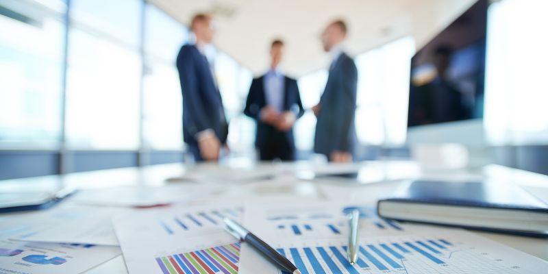 Executive-reviewing-digital-transformation-KPIs-report-in-a-meeting